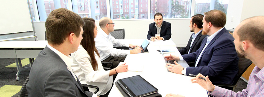 Business professionals discuss project in a meeting room