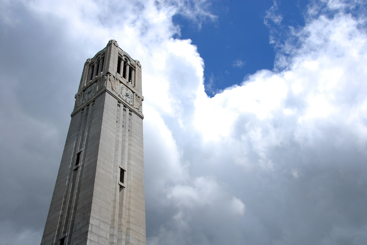 The NC State's Memorial Belltower with blue cloudy skies