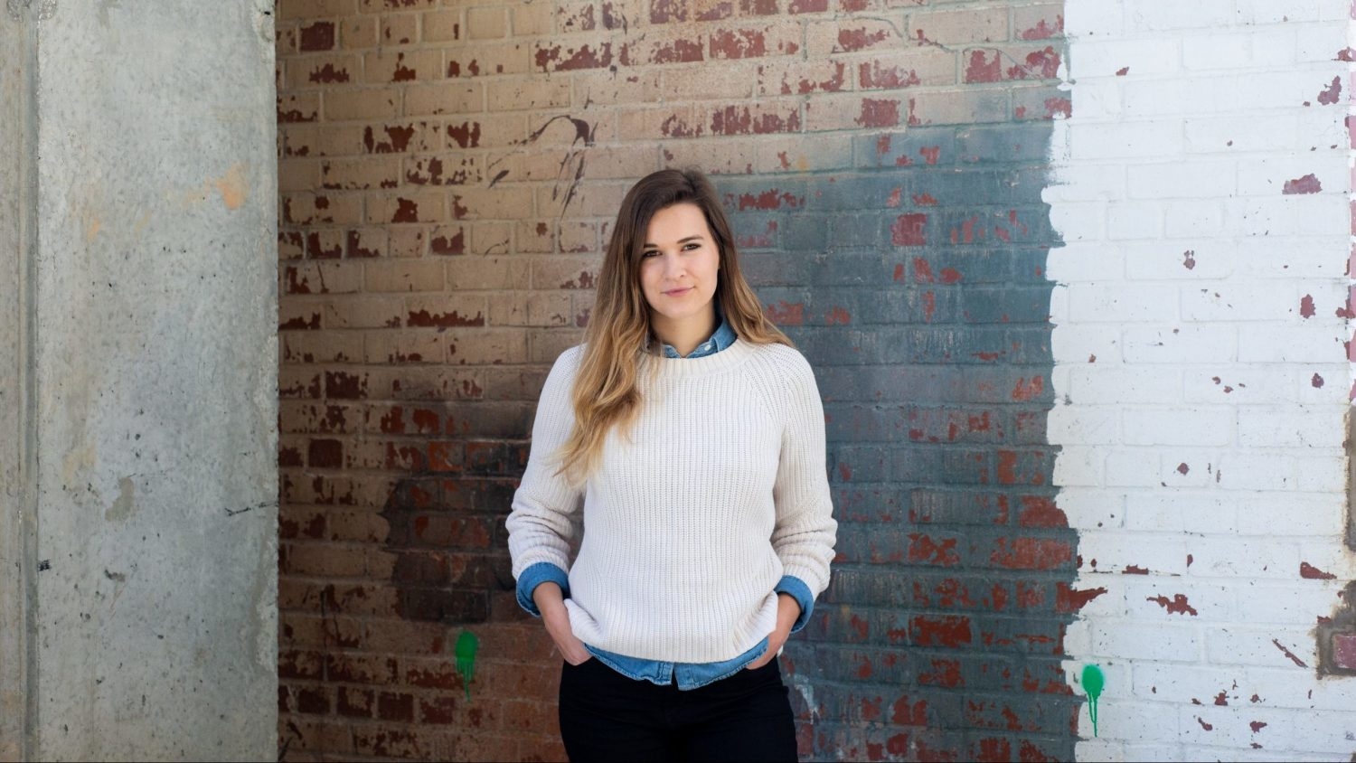 Portrait of Emily Neville in front of a brick wall