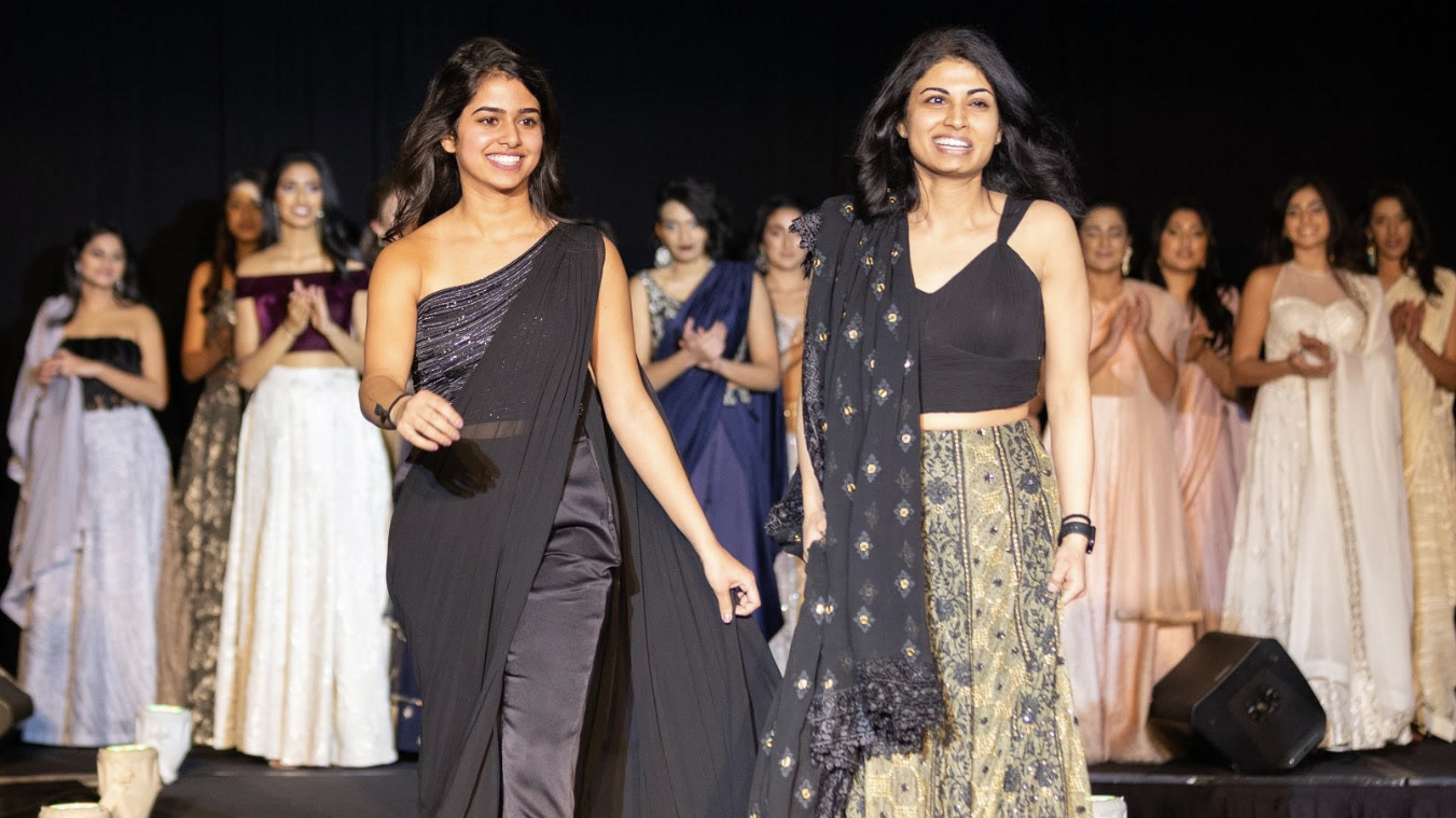 Ritika Shamdasani and her sister Niki, walk on a runway at a Sani fashion show.