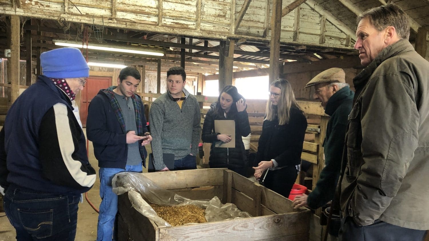 students at Biltmore farm inside of a stable