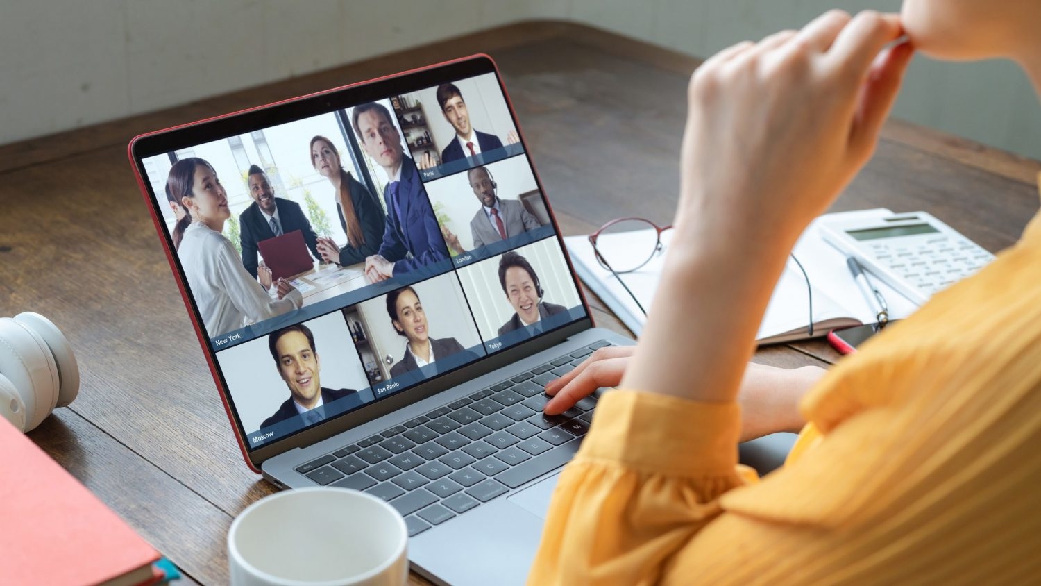 Woman attending virtual meeting from home.