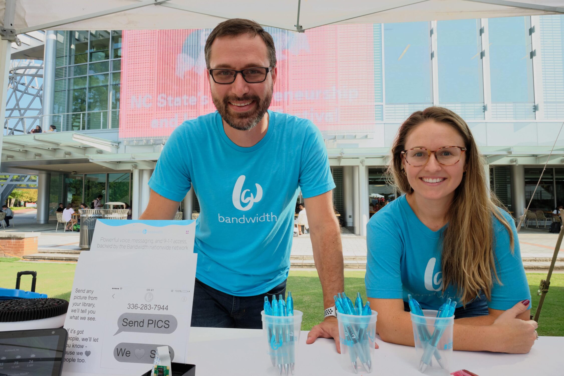 Bandwith employees smiling at booth at entrepalooza