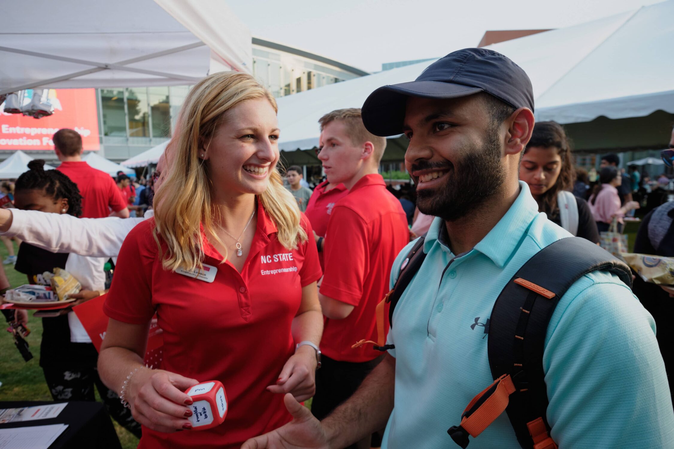 Entrepreneurship ambassador smiling with student at entrepalooza