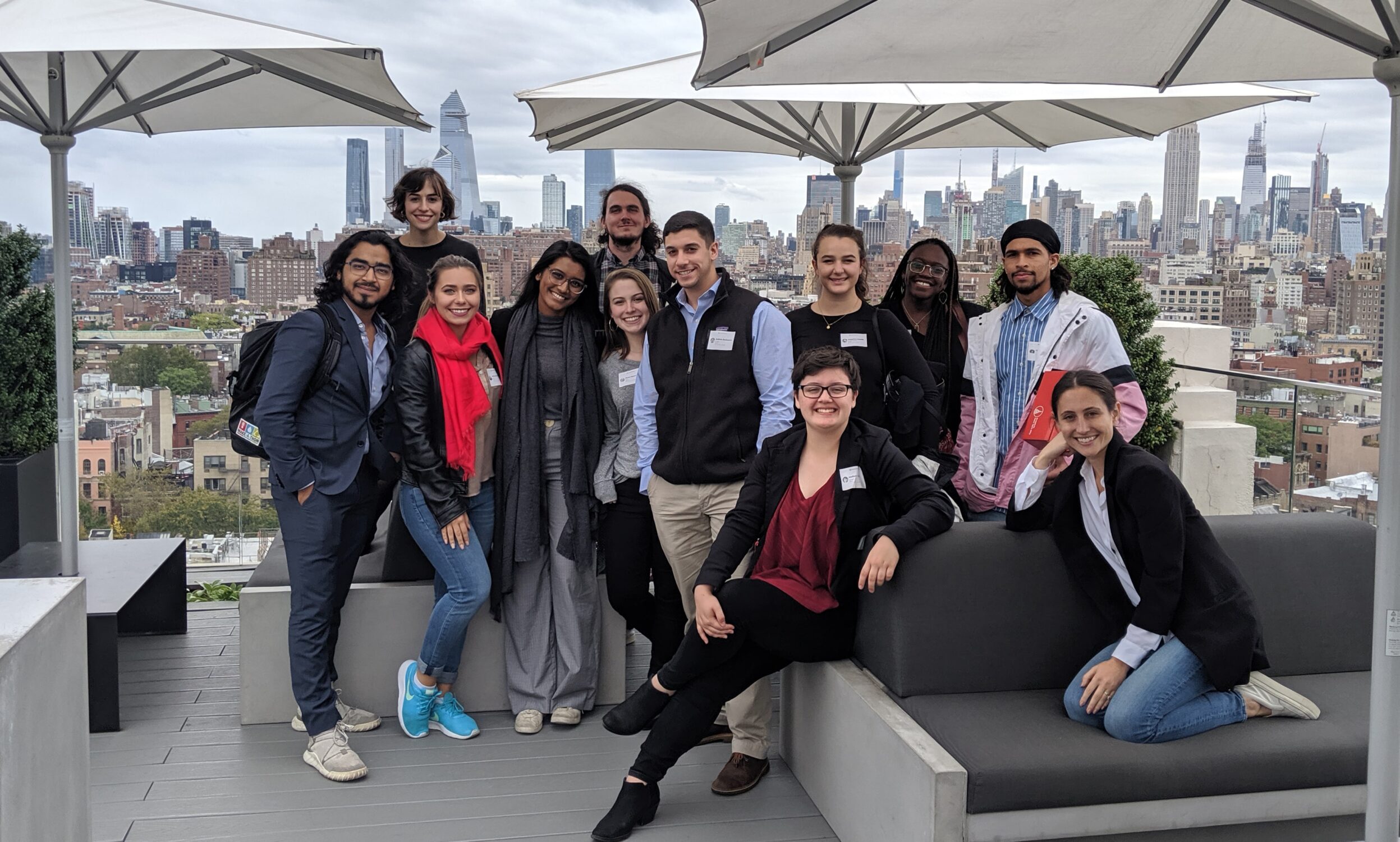 NC State Entrepreneurship students smiling on New York rooftop with city skyline in background while they visit New York for Fall break to visit startups and companies.