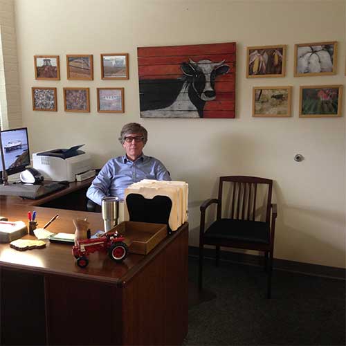 John at his desk in his office