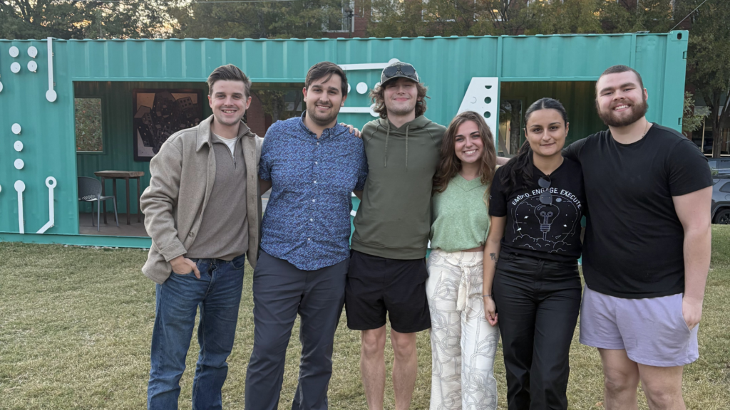 5 alumni posing for a picture