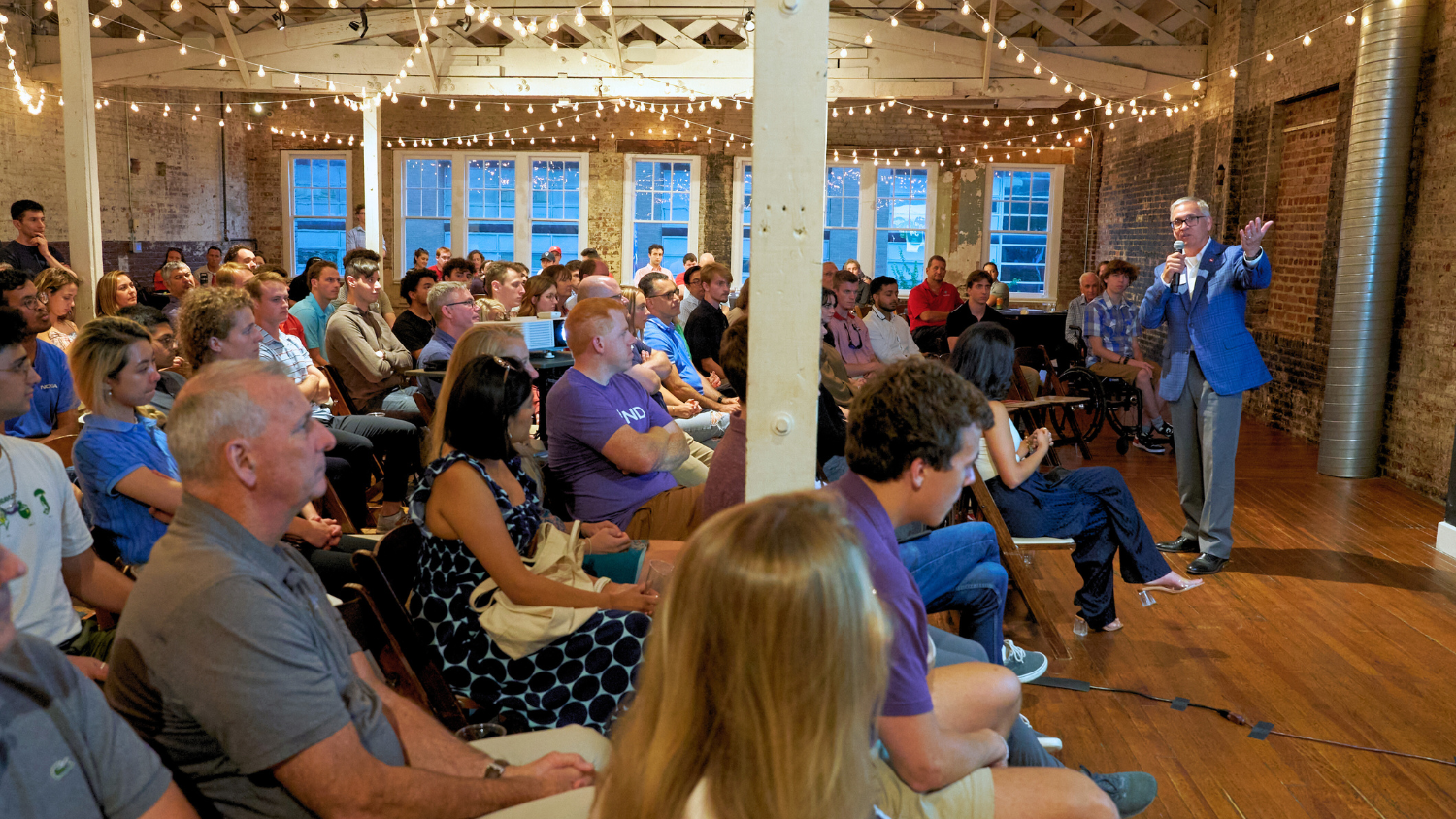 Audience listening to a man present